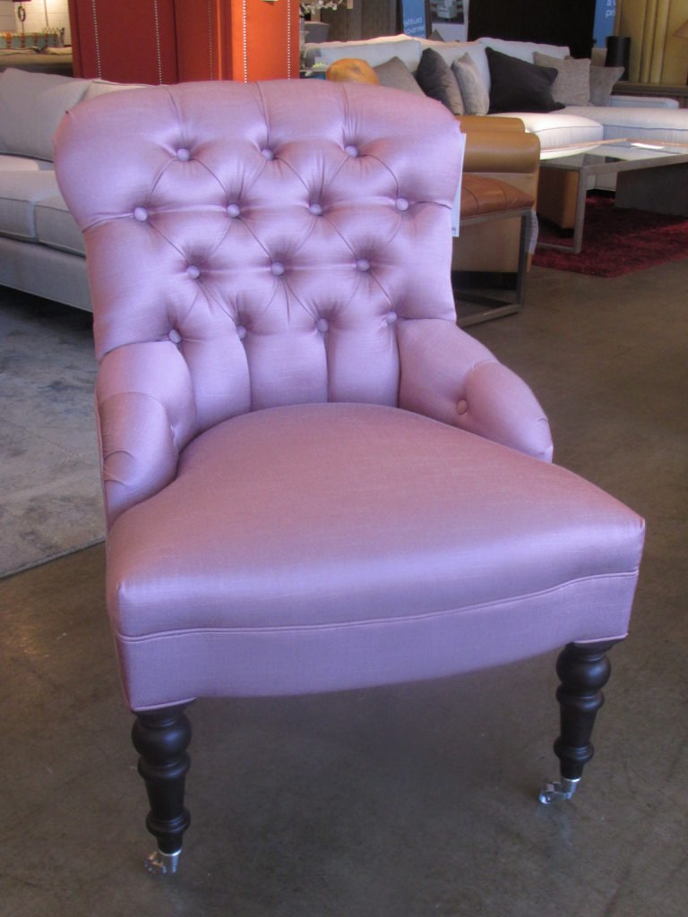 The Gloria Chair in violet, which can be found inside Mitchell Gold + Bob Williams’ Factory Outlet, is the perfect accent chair for any small space.