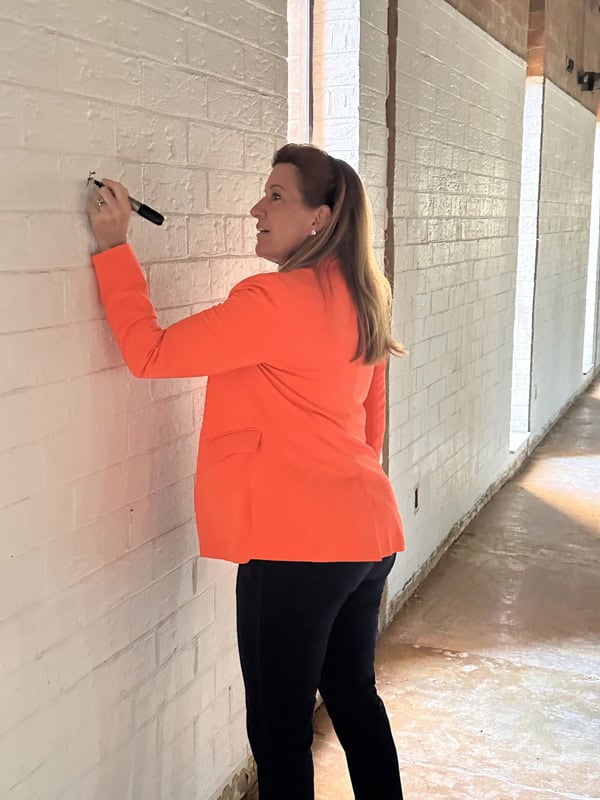 NC State Senator and survivor Woodson Bradley added her message of hope for survivors to a wall at The Umbrella Center.